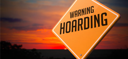 A hoarding warning sign